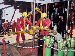 Picture of oil workers drilling